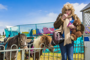 Denise takes a break, next to the shetland ponies, to re-apply make-up. A girl has to look her best.